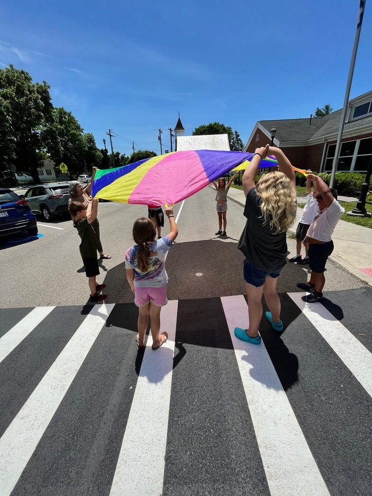 Students studying currents with parachute