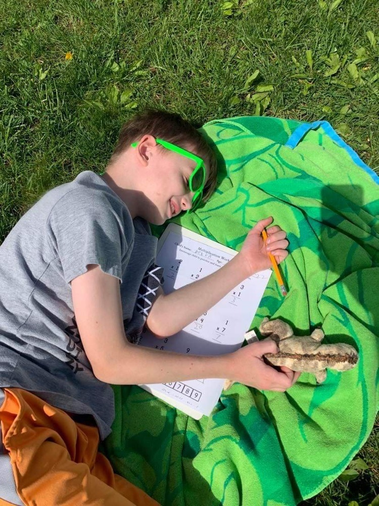 student working on math outside 
