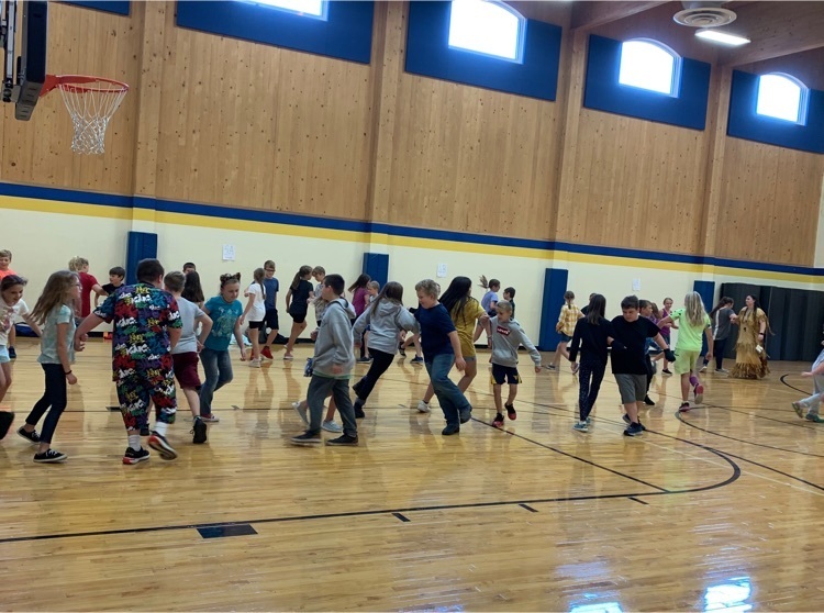 Students performing square dancing in the gym 
